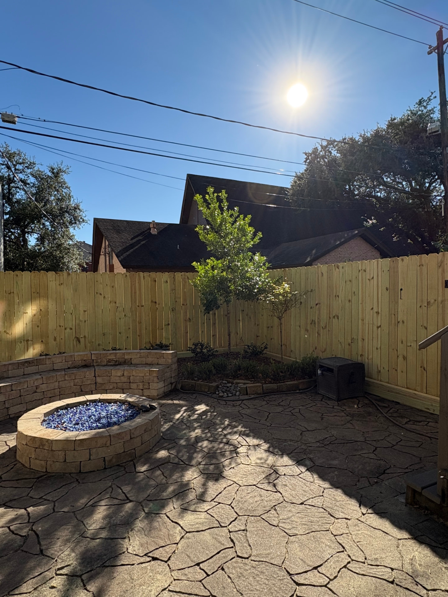New wood privacy fence installed around a backyard fire pit patio in the Heights, Houston, TX