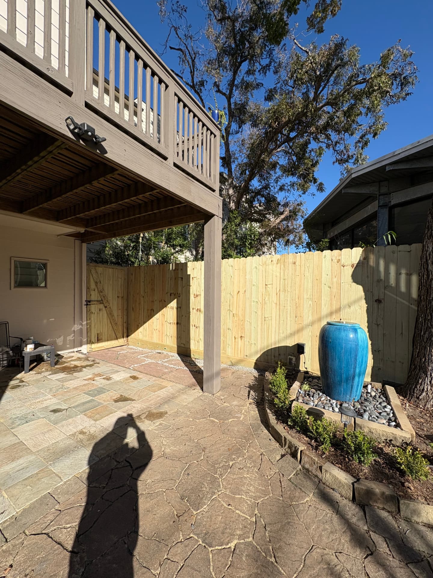 Wood privacy fence and matching walk gate beside a covered patio in the Heights, Houston, TX